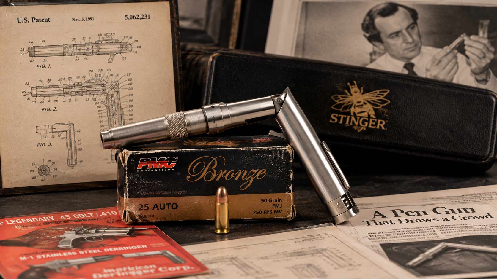 A stainless Stinger pen gun folded to fire on a box of .25 Auto cartridges, beside a case with a gold bee emblem, a patent-style drawing and a red American Derringer advertisement