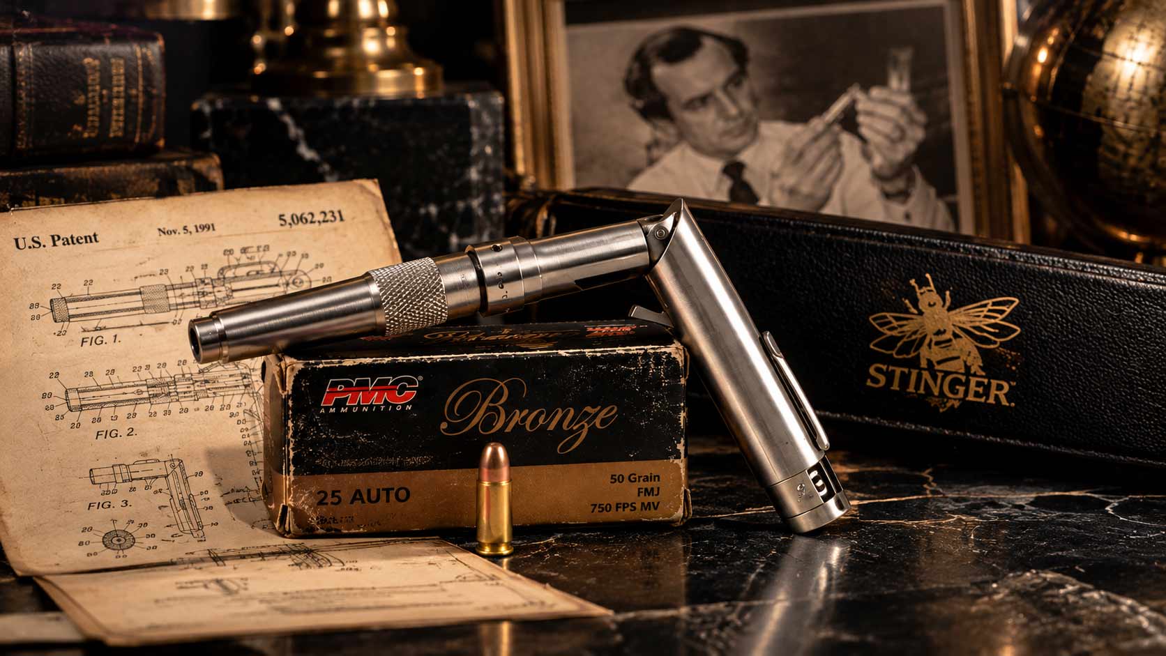 A stainless Stinger pen gun folded to fire on a box of .25 Auto cartridges, beside a black case with a gold bee emblem and a patent-style drawing