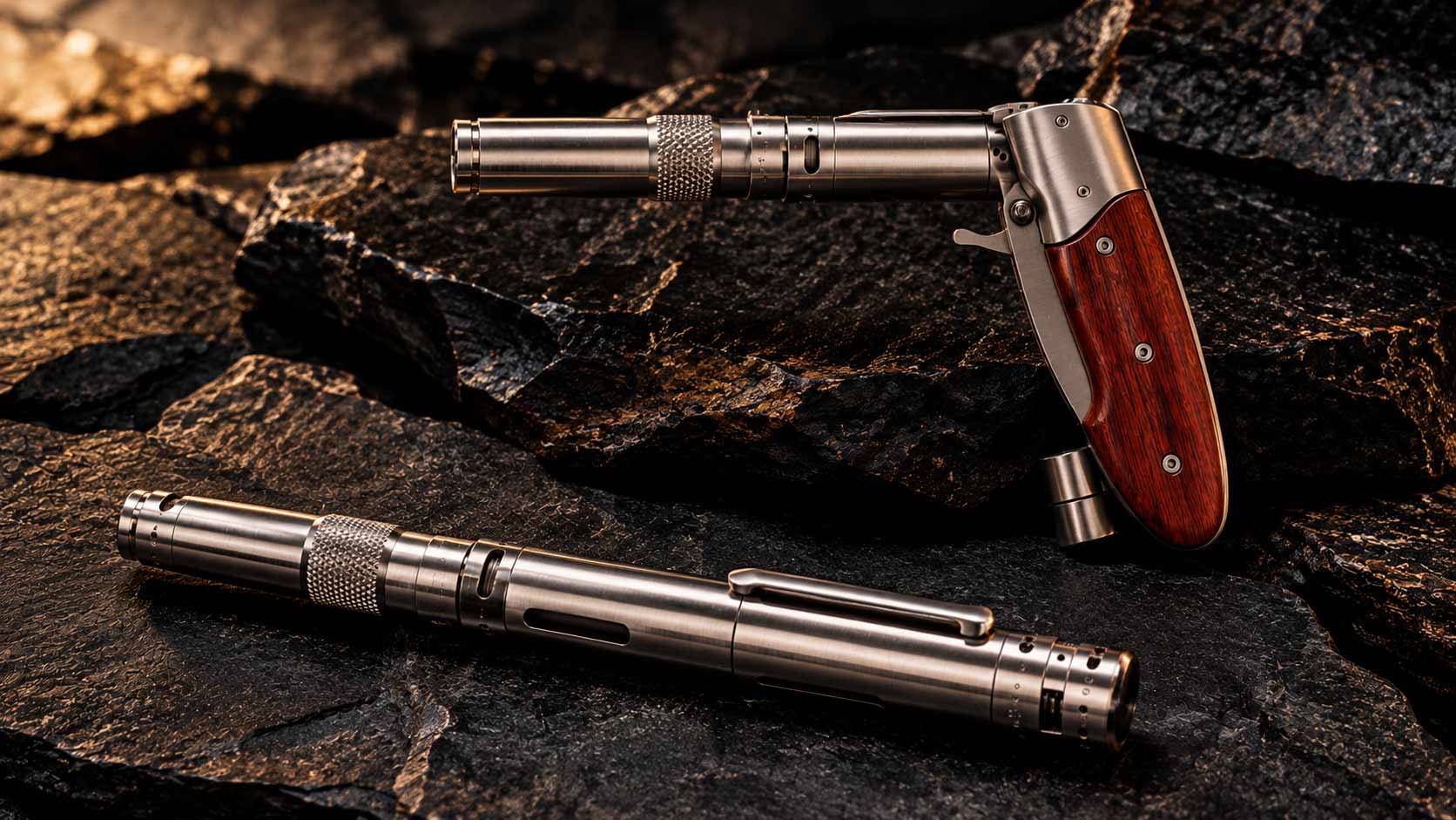 A stainless pen gun with wooden grip panels folded to fire, above a second one closed in its pen form, on dark stone