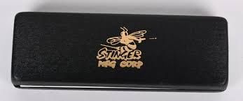 Black presentation case whose lid carries a gold emblem of a bee above the words STINGER MFG CORP