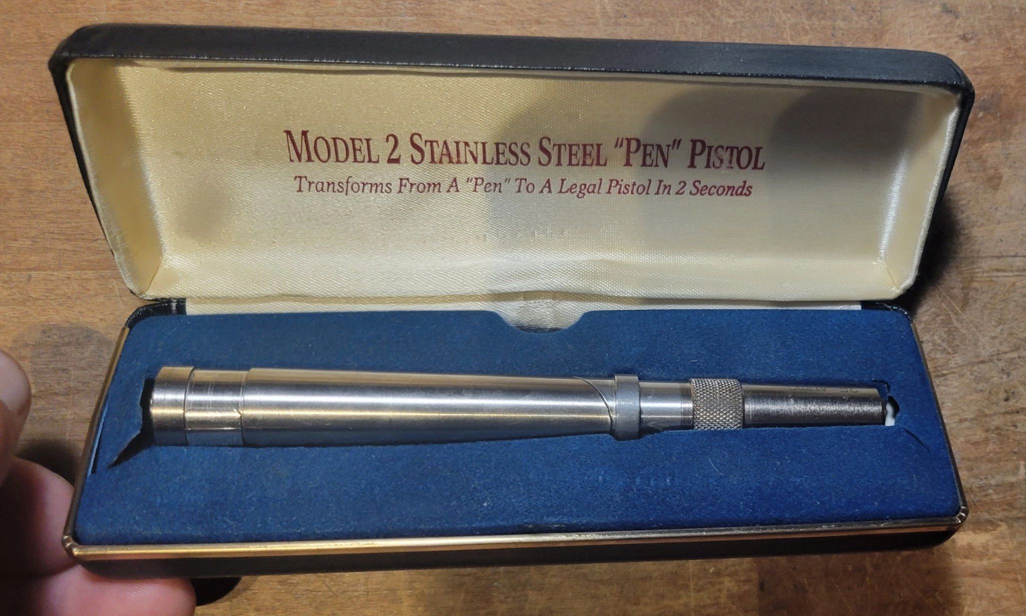 Model 2 stainless steel "Pen" Pistol in its open presentation case, the lid lettered with the model name